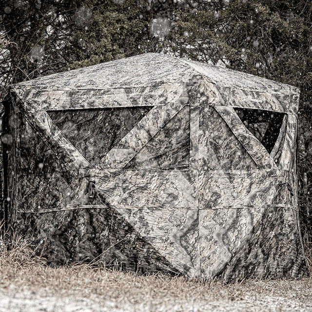 Ameristep Pro Series Insulated 59x59 pop-up ground blind with camouflage pattern set up in a snowy forest field