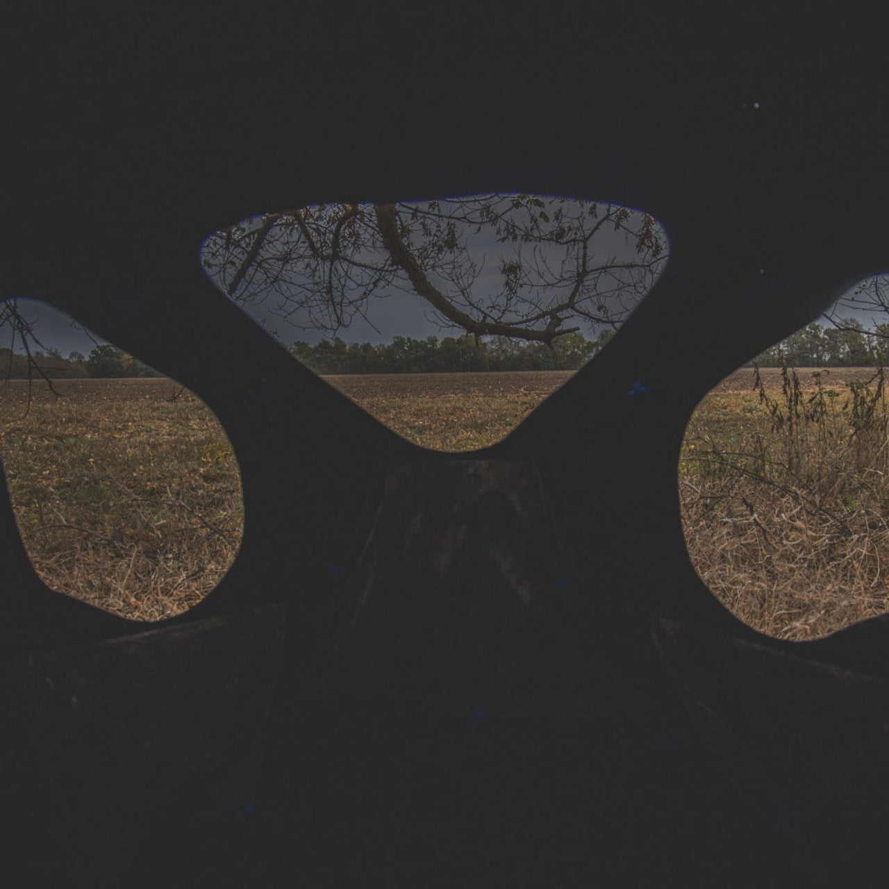 Ameristep Silent Brickhouse 59x59 pop-up ground blind interior view looking out through triangular shoot-through windows toward open field and tree line