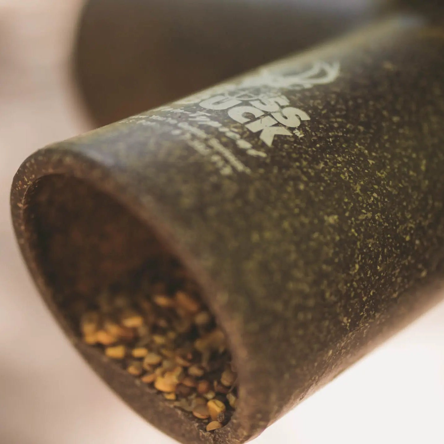 Close-up of Boss Buck 350 lb Gravity Deer Feeder feed tube — textured brown gravity port designed for smooth corn flow and durable long-term use in the field.