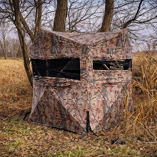Muddy Twin Peaks ground hunting blind exterior in wooded environment
