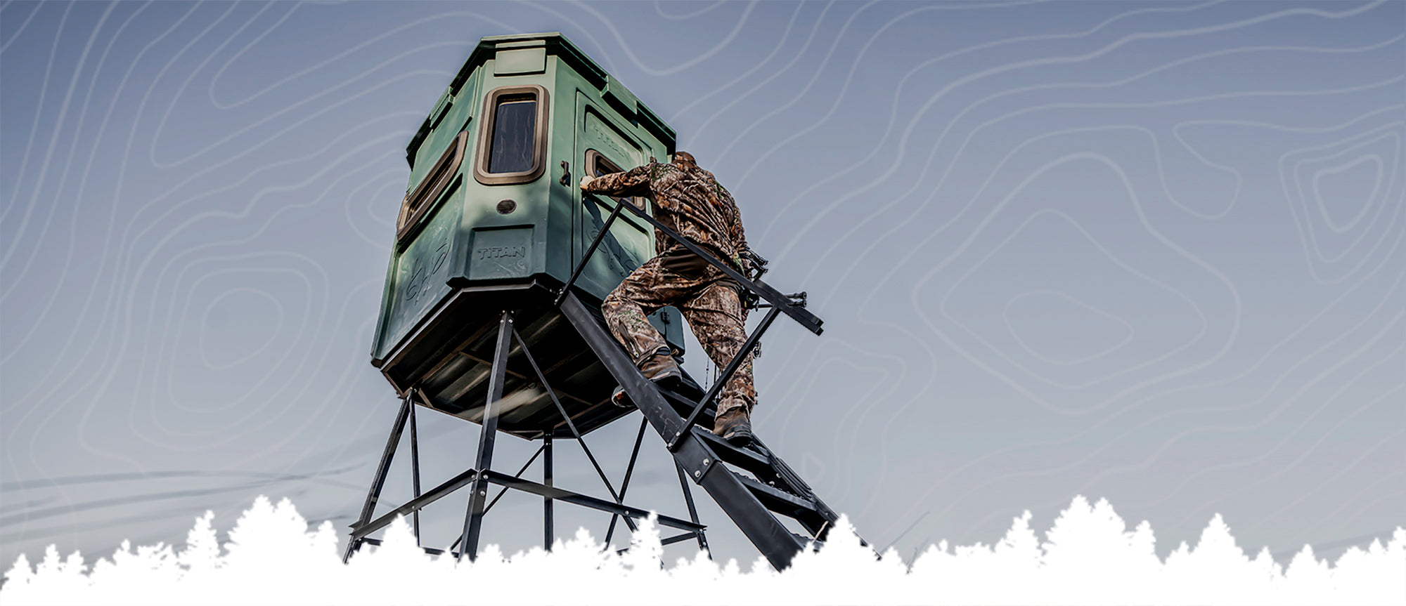 Person in camouflage climbing a hunting blind on a mountainous landscape