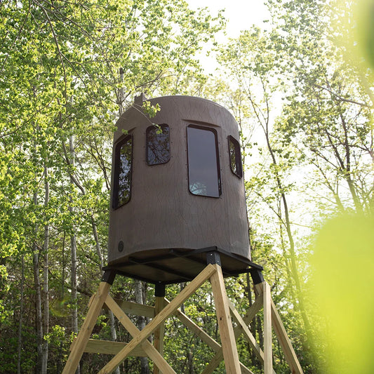 Banks Outdoors The Stump 3 360° Whitetail Properties Pro Hunter Phantom blind on wood tower, low-angle view in forest setting