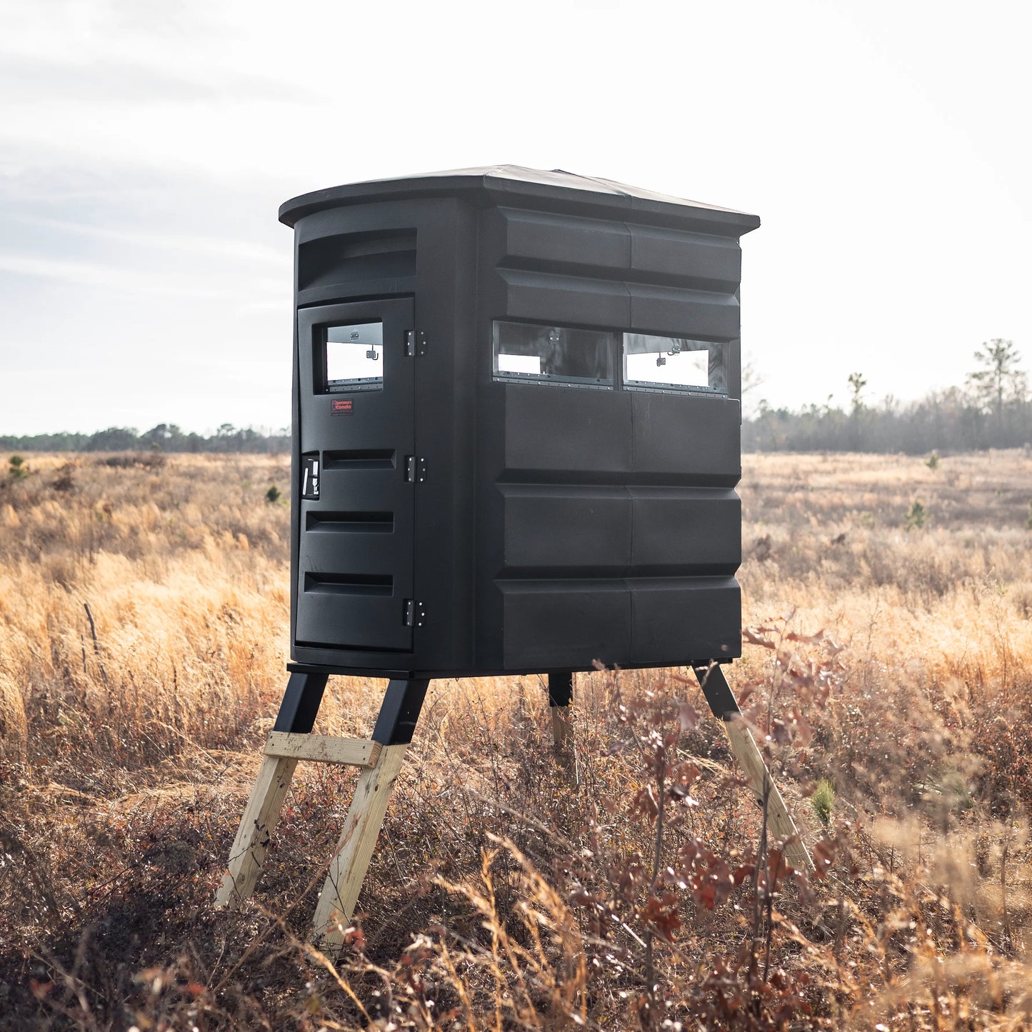 Sportsman’s Condo SC2 4x6 deer blind facing camera in a dry grass field
