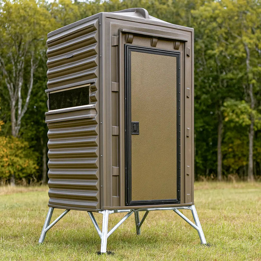 The Blynd 4x4 Deer Hunting Blind in a field with full front door and elevated stand, designed for durability and weather resistance.

