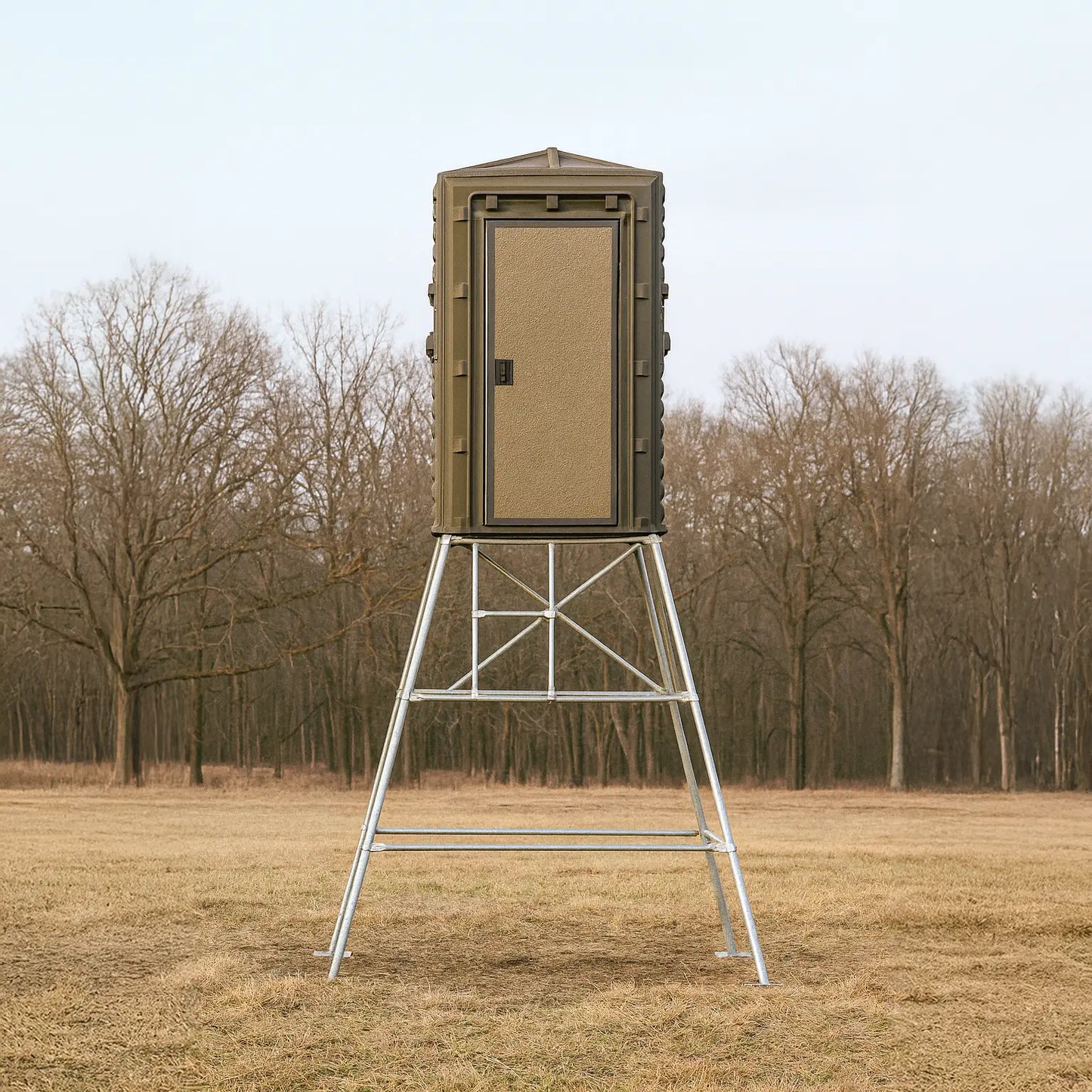 The Blynd 4x4 Bow Hunting Deer Blind elevated on metal legs in an open field, featuring full front door and rugged design for all-weather hunting.

