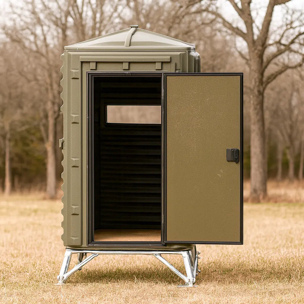 The Blynd 4x4 Deer Hunting Blind with open door showing interior, set in a wooded field for stealth and concealment.

