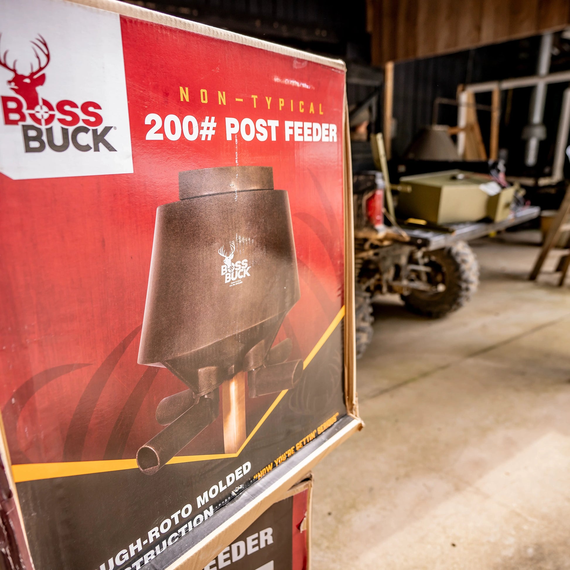 Boss Buck 200lb Post-Mounted Deer Feeder displayed in red box — heavy-duty rotomolded plastic deer feeder designed for long-lasting outdoor wildlife feeding.