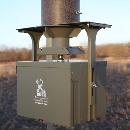 Close-up of Boss Buck 350 lb Automatic Deer Feeder spinner head — 12-volt motor and steel legs shown beneath brown rotomolded hopper for automatic feed dispensing.