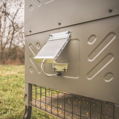 Boss Buck 600lb Stand & Fill Automatic Sled Deer Feeder showing spinner system and steel sled frame — tan rotomolded hopper with heavy-duty design for deer feeding and wildlife management.