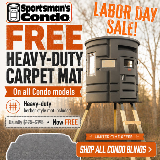 Sportsman's Condo advertisement featuring a heavy-duty carpet mat offer for Labor Day Sale. The ad shows a black condo blind on wooden legs in an outdoor wooded setting, alongside a large gray carpet mat graphic at the bottom left and promotional text offering the mat free with all condo models.