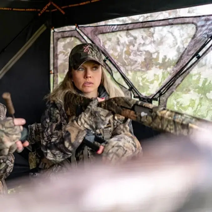 Hunter aiming from inside Muddy Epic Camo Infinity ground hunting blind