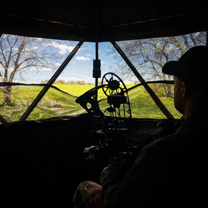 Hunter aiming from inside Muddy Infinity 2-Man ground hunting blind