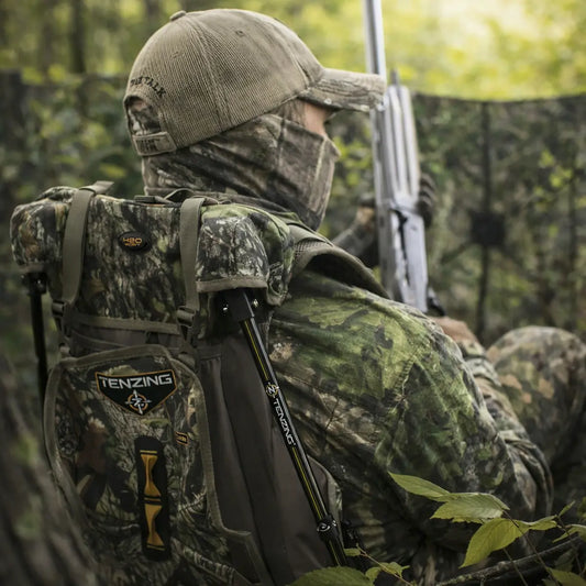 Hunter seated while wearing Tenzing Turkey Recliner vest during turkey hunt