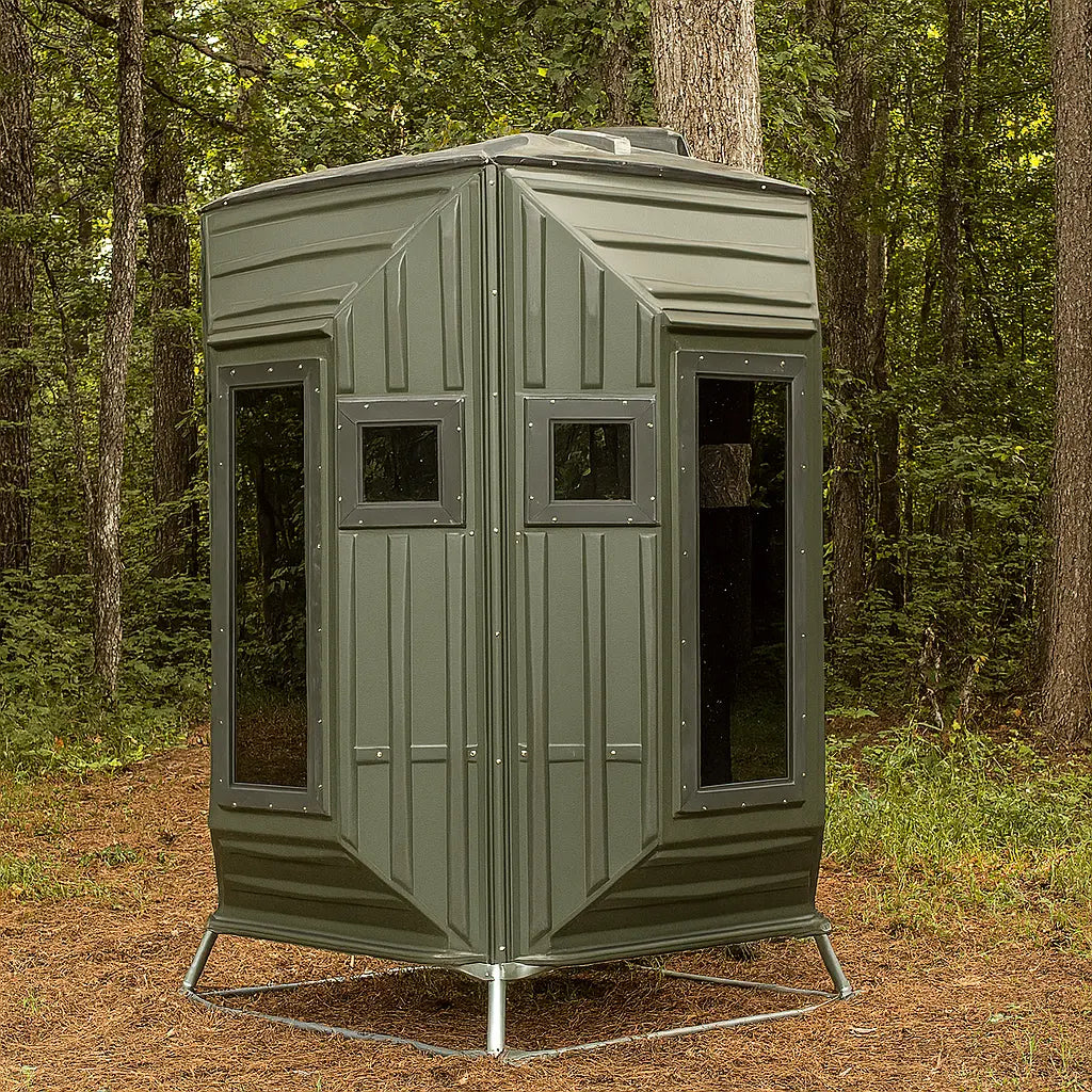 The Blynd 4x4 Bow Hunting Deer Blind positioned in a wooded forest, designed for bow hunters seeking durable and weather-resistant concealment.

