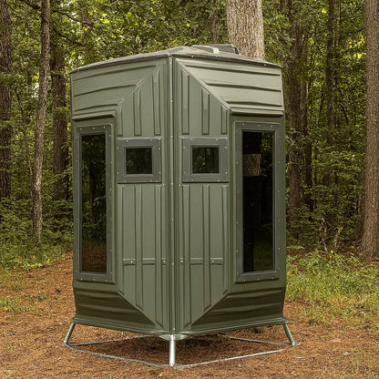 The Blynd 4x4 Bow Hunting Deer Blind positioned in a wooded forest, designed for bow hunters seeking durable and weather-resistant concealment.

