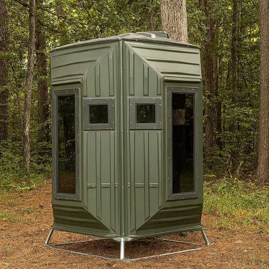 The Blynd 4x4 Bow Hunting Deer Blind positioned in a wooded forest, designed for bow hunters seeking durable and weather-resistant concealment.

