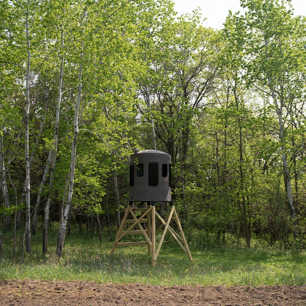Banks Outdoors The Stump 3 360° Whitetail Properties Pro Hunter Phantom blind on wood stand at field edge with treeline ba…