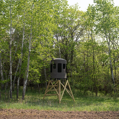 Banks Outdoors The Stump 3 360° Whitetail Properties Pro Hunter Phantom blind on wood stand at field edge with treeline ba…