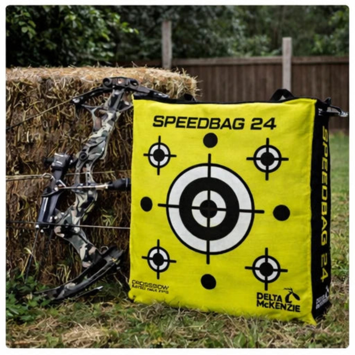 Archery bow and yellow Speedbag 24 target with target design on a grassy background