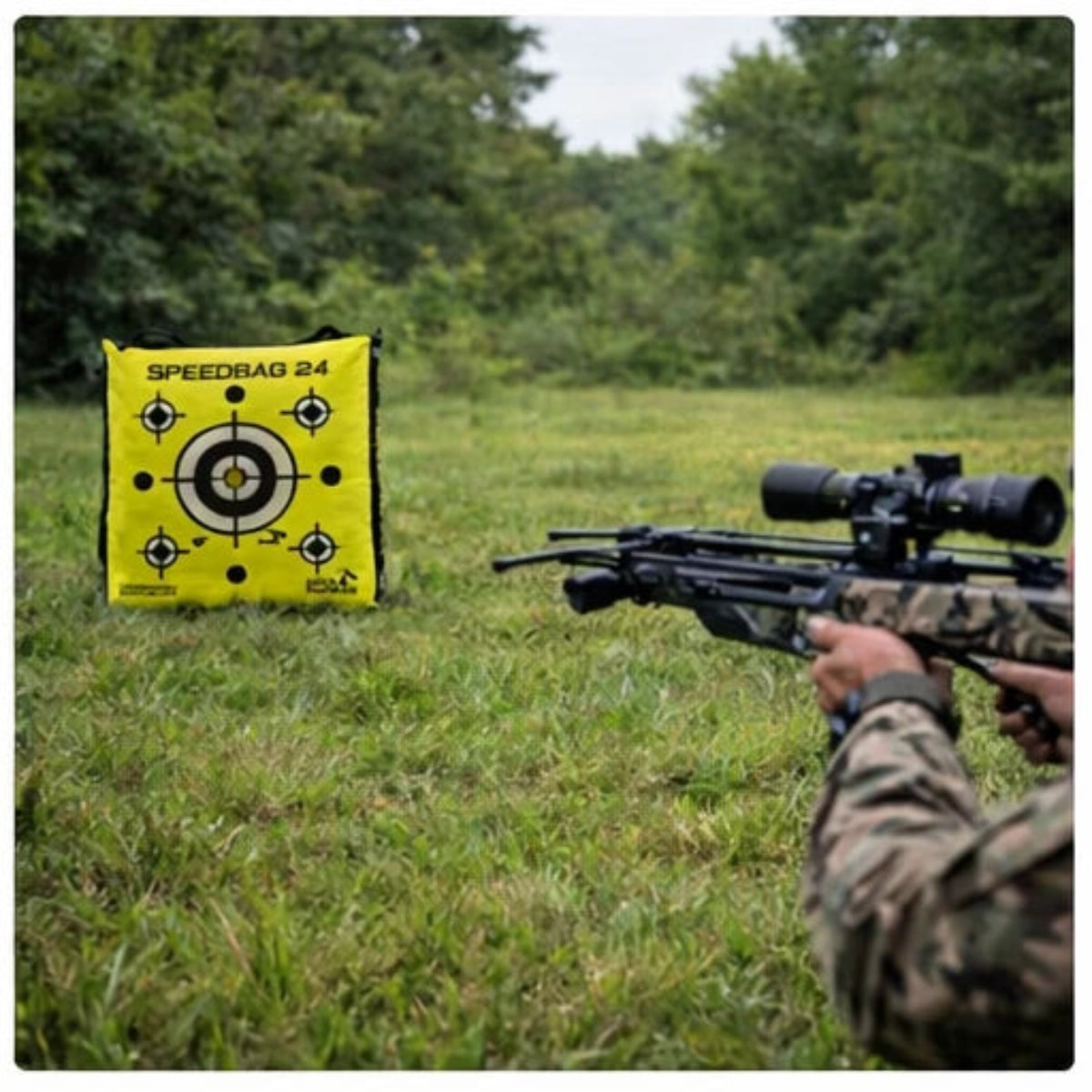 Hunter aiming a crossbow at the  'Speedbag 24' target in an outdoor setting.