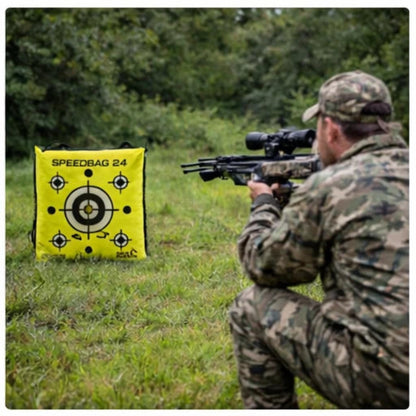 Archer in camouflage aiming a crossbow at the Delta McKenzie 'Speedbag 24' in an outdoor setting.