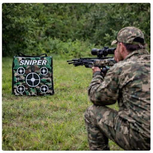 Hunter aiming crossbow at Delta McKenzie Speedbag Sniper 20-inch archery bag target in open field