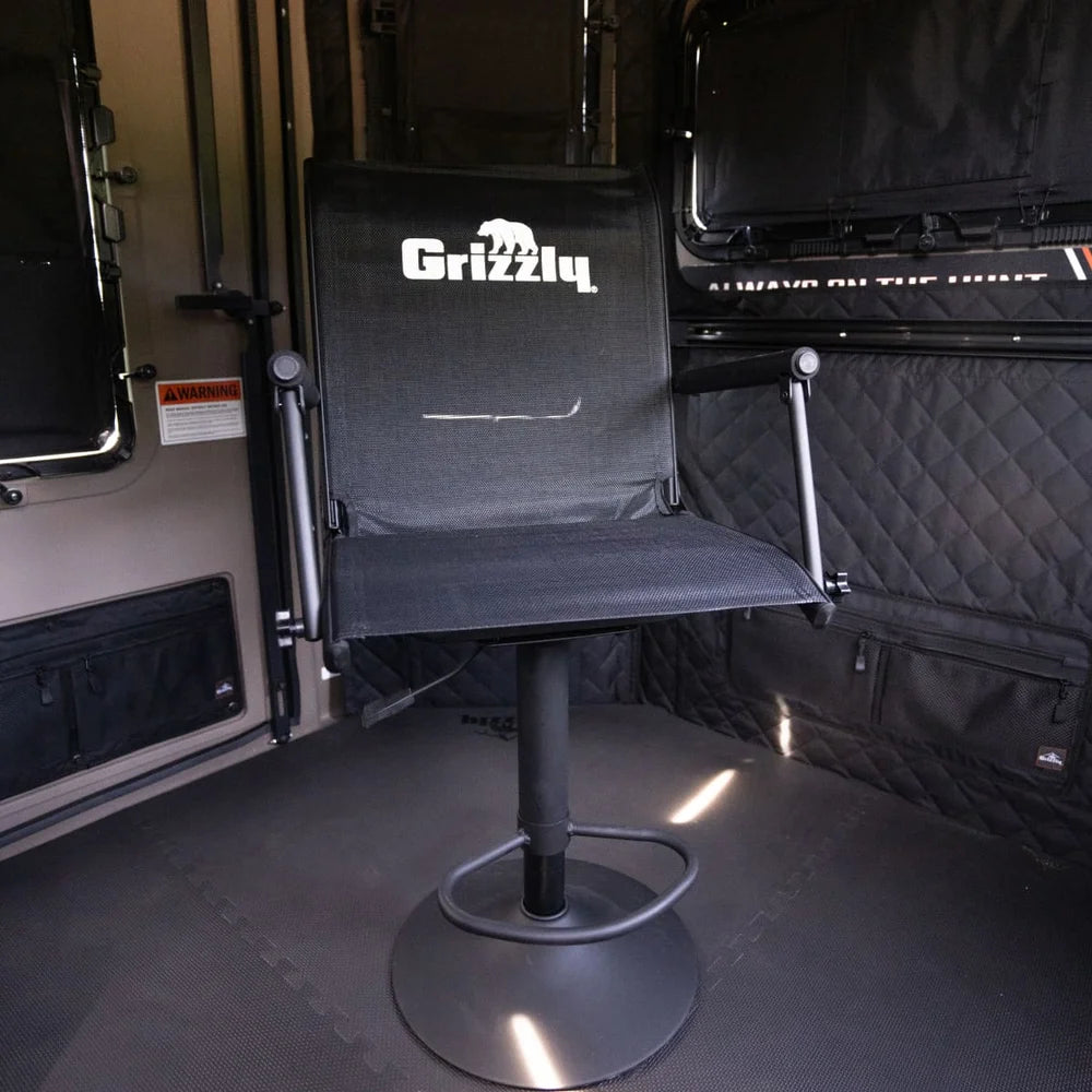 Grizzly Alpha Swivel Blind Chair front view inside a hunting blind interior with quilted wall panels