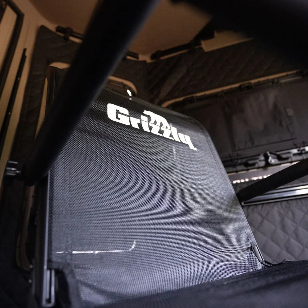 Grizzly Alpha Swivel Blind Chair mesh backrest close-up with Grizzly logo, shot from below inside a blind