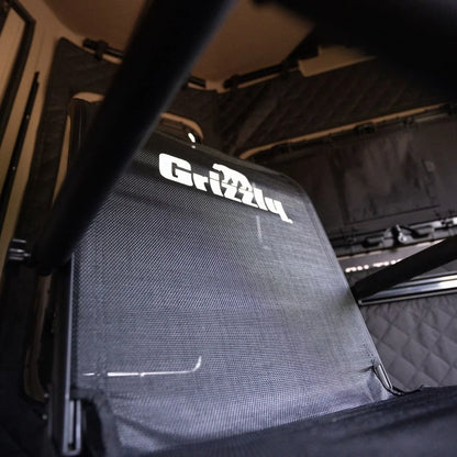 Grizzly Alpha Swivel Blind Chair mesh backrest close-up with Grizzly logo, shot from below inside a blind
