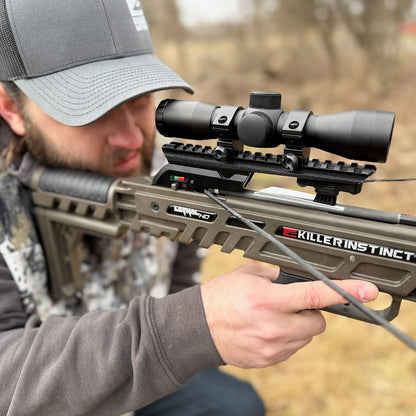 Hunter aiming Killer Instinct Lethal 405 HD crossbow in field