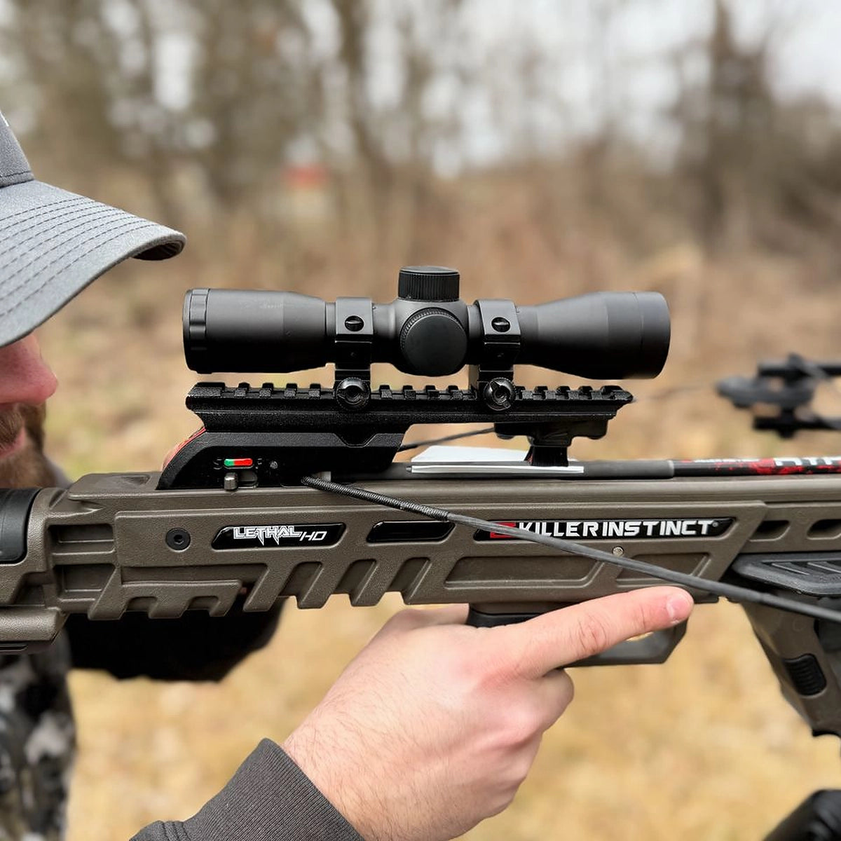 Shooter sighting Killer Instinct Lethal 405 HD crossbow on outdoor range