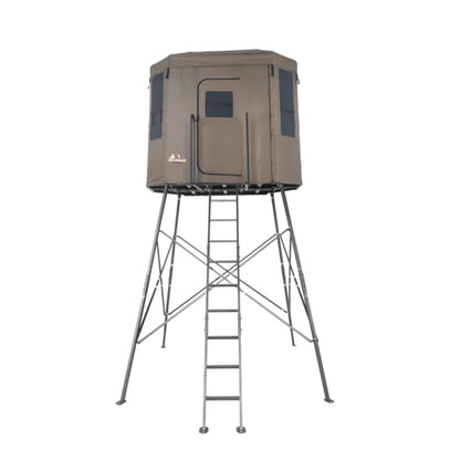 Millennium Treestands Q200 Buck Hut Shooting House, straight-on front view of tan fabric blind on elevated steel tower wit…