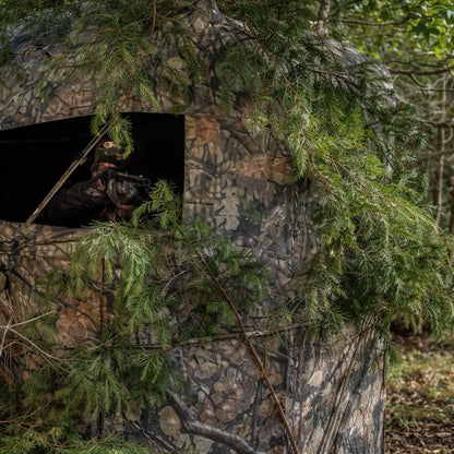 Muddy VS360 ground hunting blind camouflaged in brush for concealment