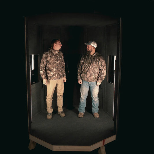 NXT GEN Deluxe Series hunting blind interior with two hunters in camo standing inside, showing roomy interior capacity