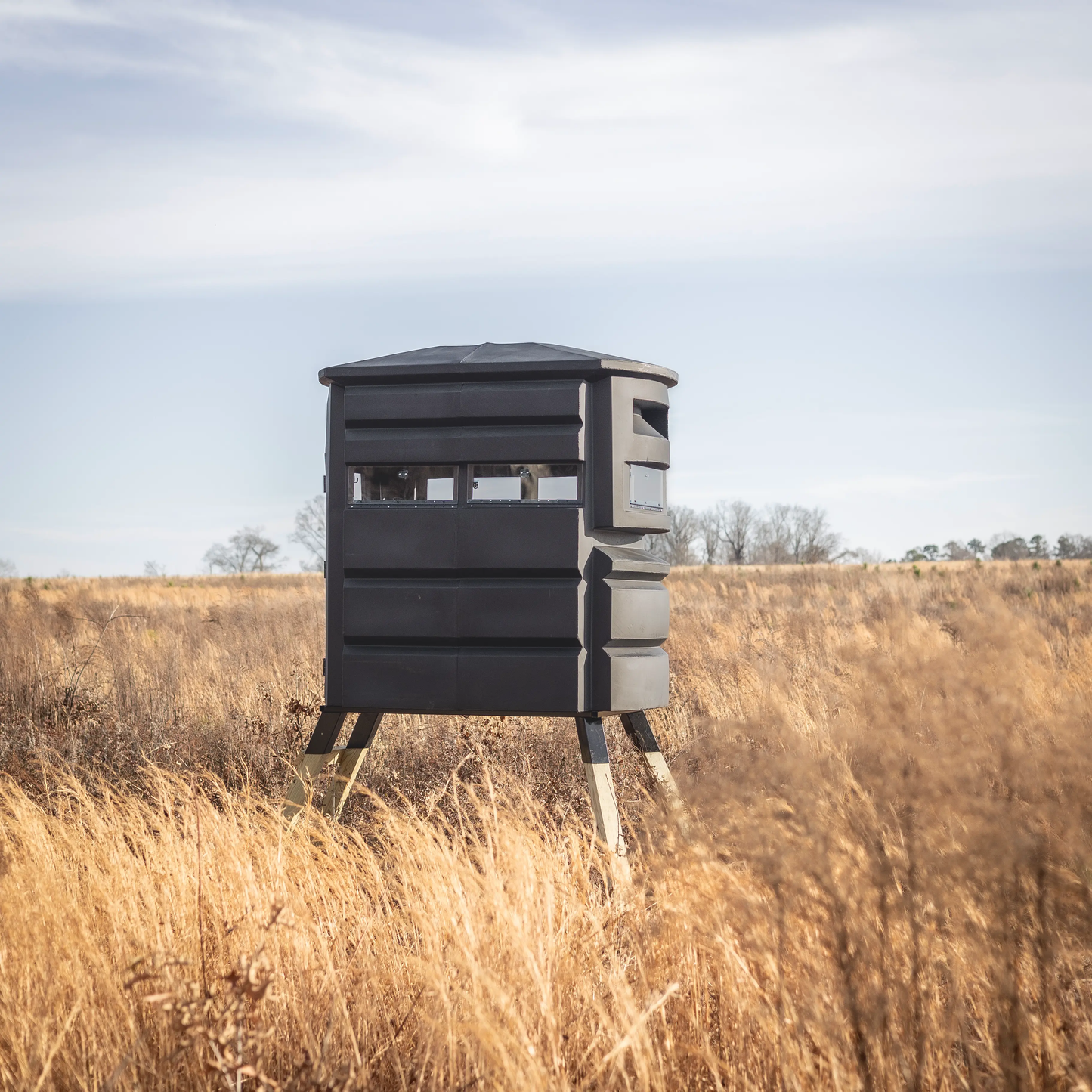 Sportsman’s Condo SC2 4x6 deer hunting blind set up in an open field, highlighting the elevated design
