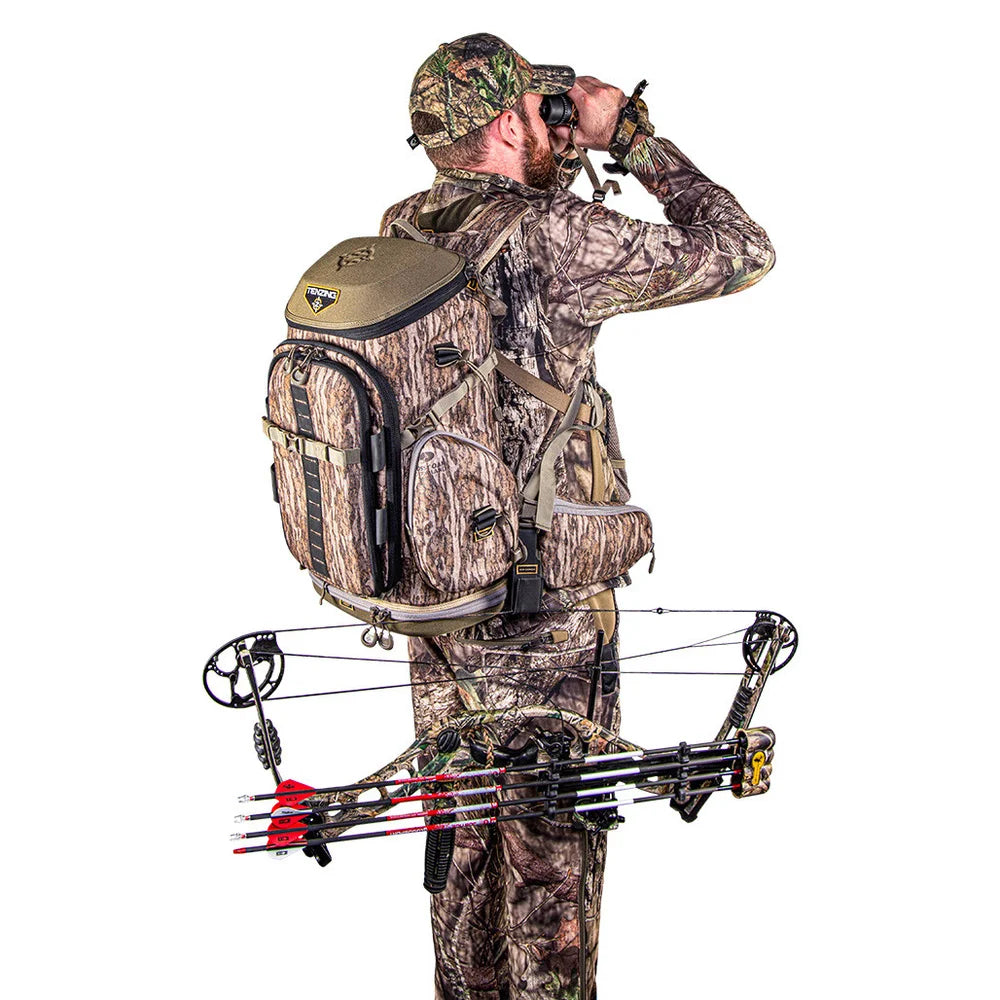 Hunter wearing Tenzing Hangtime Day Pack while glassing with binoculars and compound bow
