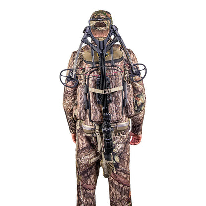 Hunter wearing Tenzing Hangtime Day Pack with crossbow mounted on front, in-use view
