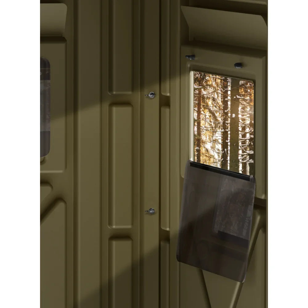 Interior view of Terrain Edge 4x4 Blind Arc Door tinted window looking out into forest