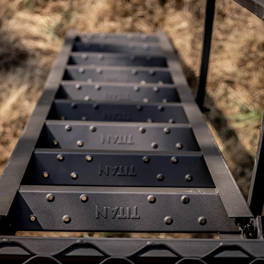 Close-up of Titan-branded ladder steps with riveted treads on the 8 ft. tower