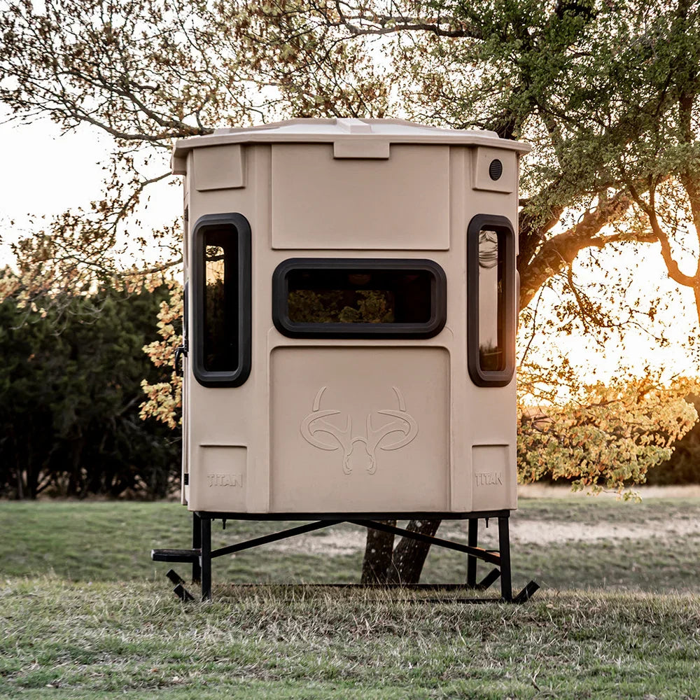 Titan Hunting Blinds Blind Base Skid supporting tan Titan blind in open field at sunset