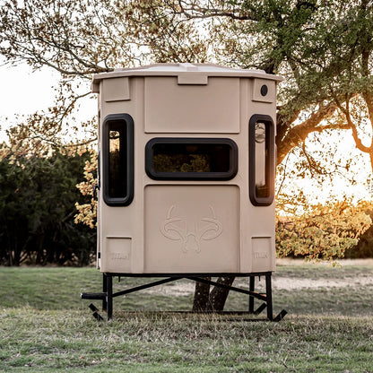 Titan Hunting Blinds Blind Base Skid supporting tan Titan blind in open field at sunset