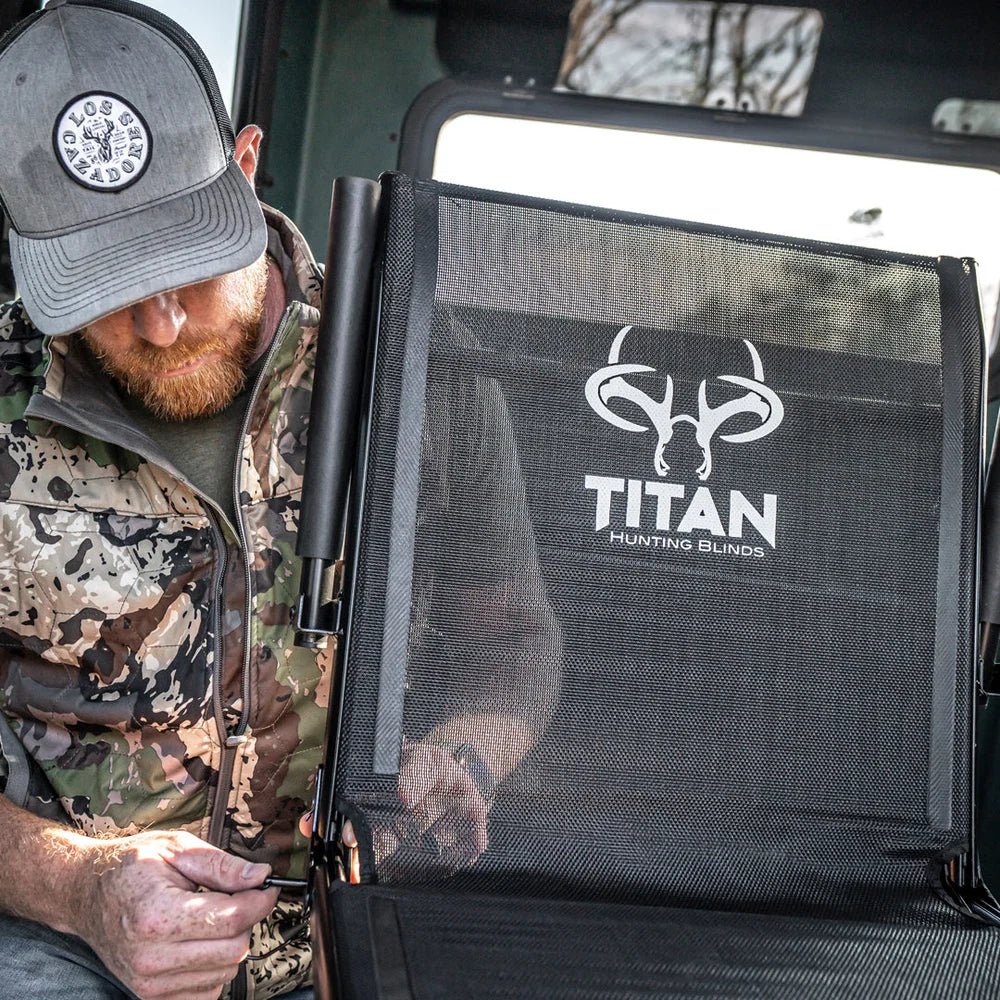 Close-up of Titan Hunting Blinds Swivel Chair seatback logo with hunter adjusting frame