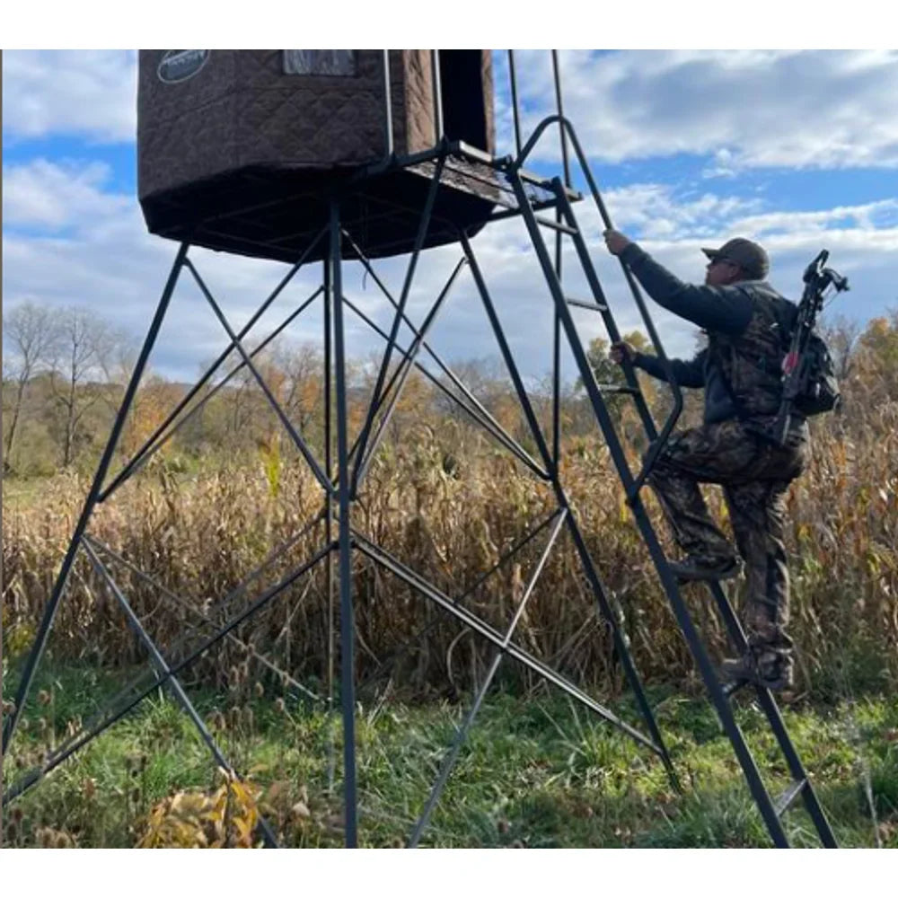 Hunter climbing ladder of Trophy Treestands D-Lux 5' Tower with blind in field