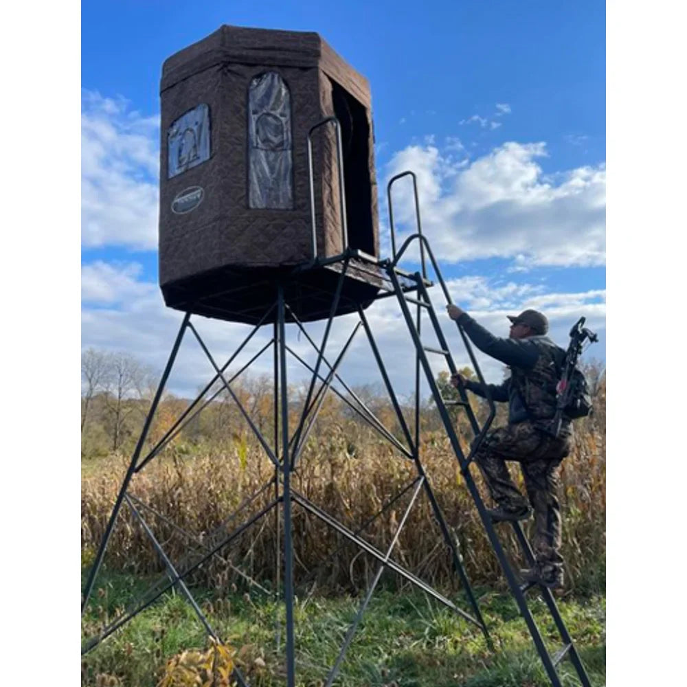 Trophy Treestands D-Lux 5' Tower with hunting blind installed and hunter climbing the ladder
